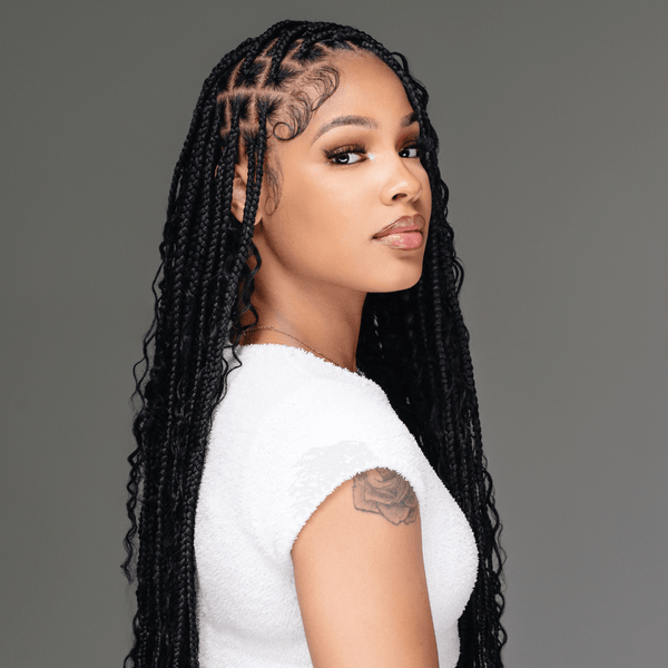 Model showcasing long knotless braids with straight roots, highlighting 100% human hair styling options.