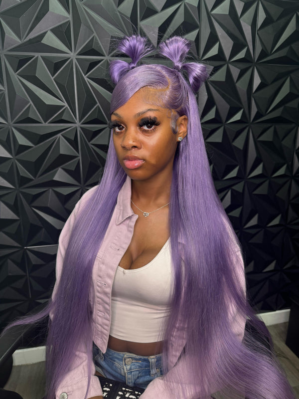 Model showcasing the Itty X Romanjay limited edition fall color wig in purple with stylish double buns.