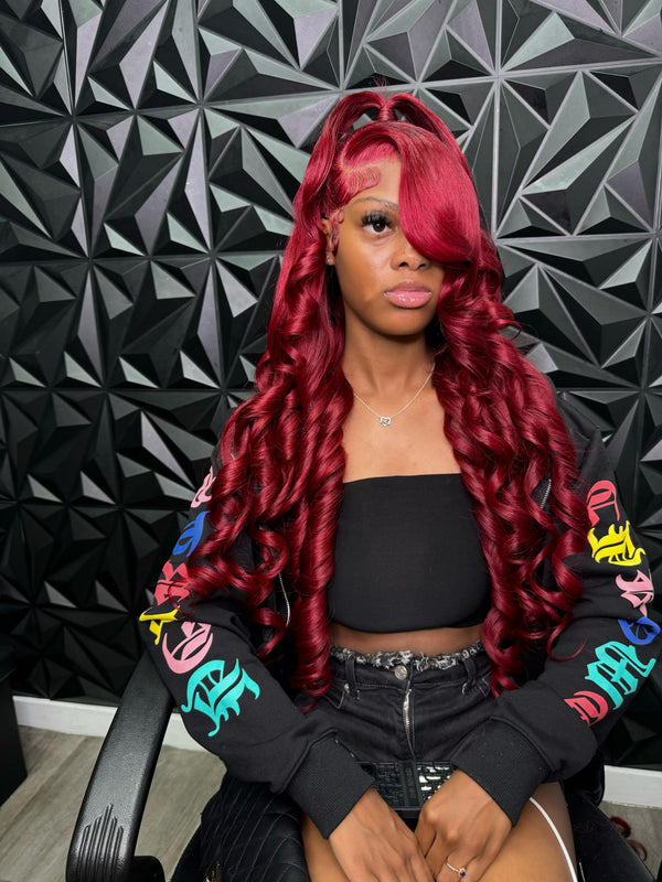 Influencer Itty showcasing the Itty X Romanjay Fall Color Wig in vibrant red curls, styled for a fashionable look.